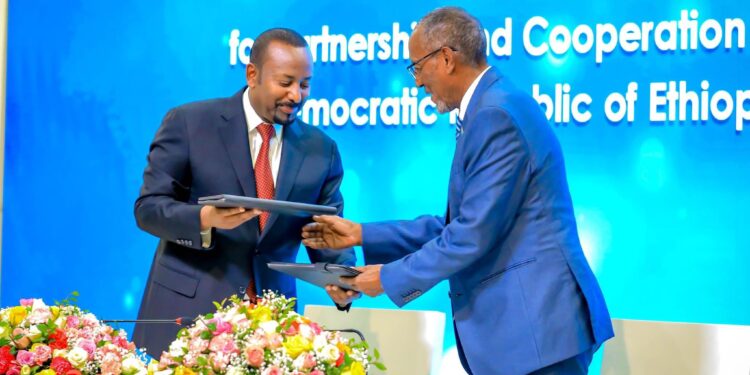 Ethiopian Prime Minister Abiy Ahmed (left) and Somaliland President Muse Bihi Abdi exchanging the MOU after signing
